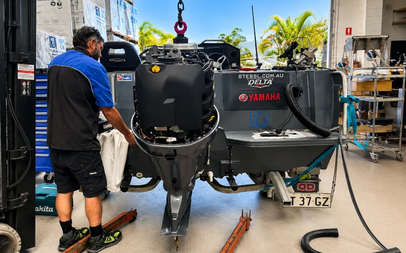 Factory-trained technician servicing a Yamaha outboard motor