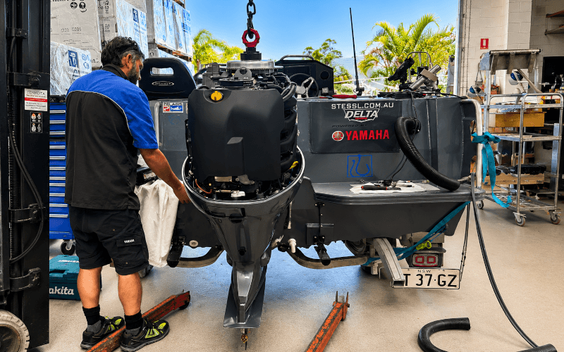 Factory-trained technician servicing a Yamaha outboard motor